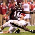 Mississippi State quarterback Chris Relf is pulled down for a sack by Arkansas defensive end Jake Be...