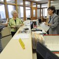 Col. Winfred Phillips, left, and his wife, Linda, of Springdale, get ballots Monday from Washington ...