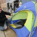 John Cunningham of Rogers talks about the small tent Wednesday he and friend Robert Smith of Springd...