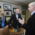 Rogers Mayor-Elect Greg Hines, middle, and wife Lisa, listen as Mayor Steve Womack offers advice and...
