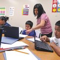 Andrea McKenna teaches a small-group ESL class on Nov. 16, at J.O. Kelly Middle School in Springdale...