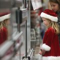 Taylor Strasner (in the Santa suit) and her sister Taite, of Searcy, look at animals at Petco during...