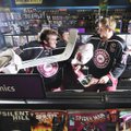 University of Arkansas hockey player Garrett Meier, right, is playfully attacked by Brendan Desjardi...