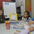 Terri Johnson, teacher at Bonnie Grimes Elementary School, reads with students at the school on Frid...