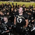 Bentonville’s Al Whiting, 57, celebrates with his teammates following the Tigers’ 49-20 Class 7A Sta...