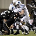 Springdale Har-Ber quarterback Ryan Luther is stopped behind the line for a loss by Bentonville’s Da...