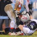 Fayetteville senior defensive tackle Athen Brandon, bottom, wraps up Fort Smith Southside junior run...