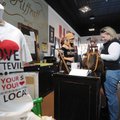 Tiffany Webb of Springdale, right, makes a purchase Friday at Riffraff in Fayetteville from owner Ki...