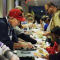 FEED THE PEOPLE - Darrell Cadotte, left, serves stuffing during the annual Feed the People Thanksgiv...