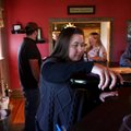 Heather Peachee, owner of Tontitown Winery, pours a glass of wine Friday for a customer at its tasti...