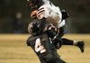 Bearden’s Defonta Lowe (top) tries to escape a tackle by Bigelow’s Justin Southerland in the first quarter of a Class 2A playoff game Friday night in Bigelow. Bearden advanced with a 21-14 victory. 