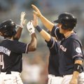 Northwest Arkansas Naturals’ Derrick Robinson, left, is congratulated at the plate after hitting a t...