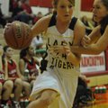 Prairie Grove’s Kendra Coyle drives to the basket Saturday against a Clarksville defender during the...
