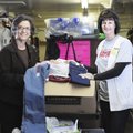 CLOTHES PANTRY Kathy Launder, right, nursing coordinator of health services for the Springdale Schoo...