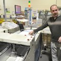 Fayetteville Postmaster Jeremy Coffey shows a sorting machine at the Fayetteville facility on City L...