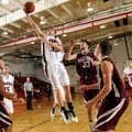 Pea Ridge’s Ethan Higgins takes the ball to the basket past Hartford’s Brandon Lunsford, center, on ...