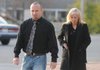 Coleman Brackney, left, former Bella Vista police officer, makes his way to the Benton County Courthouse on Dec. 2 to plead guilty to negligent homicide in connection with the fatal shooting of James Ahern in Bella Vista. Brackney was sentenced to 30 days in jail and a $1,000 fine for the misdemeanor charge.