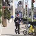 KEEPING IT CLEAN Maria Tamayo wears a Santa hat Thursday as she cleans up the walkway at Pinnacle Hi...