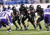 Bentonville offensive lineman Marcus Danenhauer, center, prepares to block against the Fayetteville defensive line in the first half of the Class 7A State Championship Game on Dec. 3 in War Memorial Stadium in Little Rock.