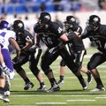 Bentonville offensive lineman Marcus Danenhauer, center, prepares to block against the Fayetteville ...