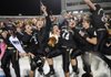 Bentonville players and fans celebrate the Tigers’ 49-28 win over Fayetteville on Friday during the Class 7A State Championship Game in War Memorial Stadium in Little Rock.