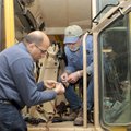 Sanjay Ahuja, left, and Lonnie Phelps install a global positioning system unit on Friday in the firs...