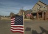 Flags wave in Bentonville’s Oxford Ridge subdivision in honor of Cpl. Chad Wade who was killed Wednesday in Afghanistan.