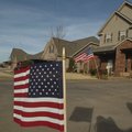 Flags wave in Bentonville’s Oxford Ridge subdivision in honor of Cpl. Chad Wade who was killed Wedne...