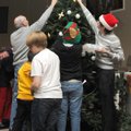 TREE DECORATING Church members gather to hang Christmas tree ornaments during the annual Hanging of ...