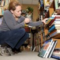  Jodi Garbison browses through the crowded shelves of books at the Trolley Line Bookshop at 110 West...