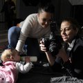 Beth Hall, right, shows Jessica Tweedy a picture of her daughter Madisyn Ware, nine months, at the ...