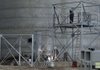 Workers construct a new grain elevator in Larned, Kan., last month. There has been a building boom for new storage facilities — particularly in Kansas and Nebraska — where crop yields have overwhelmed places to store them.

