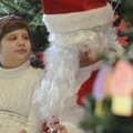  Lauren Dezarov, 10, of Rogers, tells Santa that she wants a phone, a laptop, a camera and a puppy f...