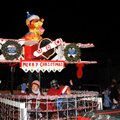 The Arvest float moves along South First Street on Monday evening in the Rogers Christmas Parade.  A...