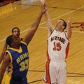 Rogers Heritage senior Zac Stewart shoots over a Hot Springs Lakeside defender during the first half...