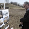 FUTURE SITE - David Allen, Siloam Springs mayor, looks over an artist’s rendering Thursday of the fu...