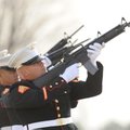 Members of an Marine Corps honor guard conduct a gun salute Thursday during the interment ceremony f...