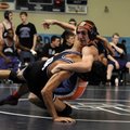 Fayetteville’s Bryan Arroyos, left, drives Rogers Heritage’s Matt White to the mat during the Northw...
