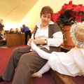 Terri Neal of Fayetteville helps her granddaughter, Avery Williams, 3, with her angel costume before...