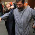 Costume manager Phyllis Bishop helps Scott Kyles don the robe of a disciple during a fitting session...