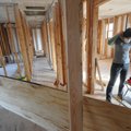 Lauren Kuenzel prepares to cut a piece of plywood Thursday. She purchased a bank-owned home with hel...