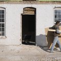 Brandon Eoff with Dynamic Construction of Garfield, cleans up construction material Wednesday around...