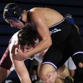 Fayetteville’s Dalton Alston, top, fights to take McDonald County’s Daniel Sumler to the ground duri...