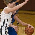 Siloam Springs’s Makenzie Sharp reaches for the basketball as she blocks the progress of Rogers High...