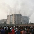 A crowd gathers as smoke rises from a garment factory on fire at Ashulia, about 25 km (16 miles) nor...