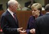 German Chancellor Angela Merkel speaks Thursday with Greek Prime Minister George Papandreou during the European Union summit in Brussels. 