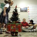 Abigale Perry, 5, left, and Rebecca Garcia, 5, tow their homemade floats Thursday past students lini...