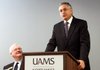 Peter Kohler (left), vice chancellor for University of Arkansas for Medical Sciences-Northwest Arkansas, listens while UAMS Chancellor Dan Rahn speaks Thursday during a news conference at the school’s Northwest Arkansas campus in Fayetteville. Rahn announced a $650,000 donation from the Wal-Mart Foundation.
