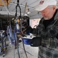 RUST REMOVAL Ronnie Holland paints a rust-removing gel on an old Texas Rangerette bicycle Tuesday at...