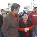 Mary Robles of Bentonville sheds a tear Friday after receiving her vehicle from Keith Brown of Brown...